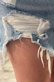 The front ripped on the first wear. I know they're distressed denim, but the holes are so big now they look terrible and are unwearable, so bummed that they only lasted one day! The fit was fine, but the material was too thin, not what you would expect for $70 shorts. - Megan M.