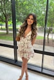 I wore this for a friend's graduation and it was SO flattering I got so many compliments on it! 
It does run slightly large and I had to use double-sided tape to keep the shoulders from falling off but otherwise the perfect romper. I'm wearing an XS! - Brianne H.