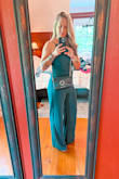 I originally bought the medium but had to exchange for the small. The Medium fit except for the fact that it was about four inches to big in the crotch area. Lol The small fit better! The length was pretty long, but I wore wedges and it helped. I got so many compliments on it!! - Nicole G.
