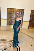 It runs true to size, it was a bit long for me but everything is long on me cause I'm only 5'0" tall. I wore heels and didn't really have to hem it. Was getting compliments all night! - Iana C.