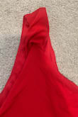 Part of the strap was sewn into the seam, so the shoulder strap was all bunched up.  I was worried I wouldn't be able to get a replacement in time, so I took a chance and opened up the seam to cut it out.  Stitched it back up and it's fine, but this was an obvious flaw that should have been caught. - Lee T.