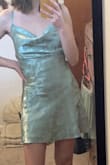 This dress was the exact color portrayed in the photo and fit great from the waist down(although it was very short and I'm not very tall). However, I'm on the small bust side of things so the cowl neckline wasn't super flattering. Will return and get something else. - Nevaeh H.