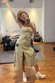 A little looser than I thought it would be but still super cute. The fabric is a bit stiffer than anticipated so have a steamer ready. Styled with similar boots as the model and I 100% recommend it! - Grace N.