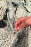 I never even wore the dress to the weddings tags are still on and the zipper is destroyed. I was putting the dress on (the dress clearly fit) but the zipper was just getting caught at a certain point. I took it off to take a closer looked and the zipper completely came apart at the bottom. It's the day of the wedding and now I have to find a new dress. Very frustrated. - Kelsey T.