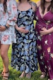 I bought this for a wedding, and I'm a few months pregnant. Enough to have a small bump but not enough to pull off a bump-focused dress. This is this first dress I've bought from Lulus and the quality was great. It was very comfortable to wear for hours at an outdoor wedding. I'm pretty busty with an average butt, and when I'm not pregnant, a more defined waist. If you have a similar body type and you aren't pregnant, a small may work better! The stretch in the back and tie straps allow a lot of give. Also the length was a perfect midi for my height! - Tasi T.