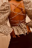 I recently purchased a back open top, and I am absolutely thrilled with my purchase. This top has quickly become one of my favorite pieces in my wardrobe. The design and style of the clothing item were modern and versatile. - Bana Z.