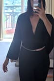 Cute, is reversible but looks a little silly in the front when worn with the slit in the back. Sleeves are about an inch or two too short. Smells atrocious when you buy it but whatever. - Ro M.