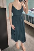 This dress kept catching my eye but I wasn't 100% sold on it. I decided to buy a few dresses to try on for my sister's wedding and added this one to the lot. I was surprised by how much I liked it in person, especially the cute tassle like straps! I did end up returning it since I went with another dress but it's still a gorgeous option. I typically wear size XS or S and ordered XS based on the size chart. I was a little surprised by how snug it was, especially in the chest since I don't have big boobs. It did however make them look really good, just couldn't wear the dress with a bra because there wasn't any extra room. The zipper was a little wonky too and I had a hard time zipping it but not because it was too small. Definitely worth a try though if you're on the fence about it. - Grace W.