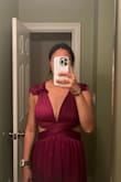 I fell in love with this dress online but when it came in the mail it fit horribly. The sizing runs small and I could barely fit in the top part. The dress wouldn't zip all the way and it was just very unflattering overall. For the price, I would not buy this dress because it looks completely different in person. Unless you are petite and small chested I would not recommend. I'm pretty muscular and wide-shouldered on top so it was hard for me to even get the top part on. It has no give and it's a very short section overall. In the first photo, my boob is at the end of the band rather than the cup section. - Cindy C.