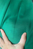 The dress is a beautiful color, the material is thick but feels well-made. The fit is great and is quite flattering. 
My disappointment was in the quality control. There is a "crease" that runs down the back of the dress a couple of inches away from the zipper. The problem is that when it's on it shows that the material is a darker color of green down the entire length of the dress. So the crease doesn't ever go away it stays even when stretched out and looks like someone took a marker and drew a dark green line the entire way down the back. My event is too close to try and return it but still unsure if I will wear it with that running down the back. - Shauna W.