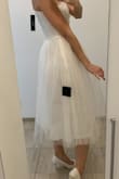 I bought this dress for my wedding like a dress to change after midnight, but I am sending it back right after trying it on. The tulle skirt has no form (maybe it would have if I ironed it), it looks unflattering, and it moves differently from the skirt under it. But the biggest minus is that the material is extremely itchy and very uncomfortable, I couldn´t stand being in it for 5 minutes, I think it´s because there is the tulle material also on the inside somehow. The only star is that the XS size was true to size for me. - Bianka B.