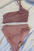 I ordered this swimsuit last year and the top is purple and the bottom is pink. It's super noticeable. I'd love it if the top matched the bottoms! - Hallie W.