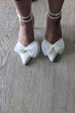 I loved the shoes in the pictures, so bought them for my wedding (will definitely have backup sneakers for when my feet get tired). Tried them on one time. they looked good and seemed comfortable. It was a little difficult to get the straps correct since there were no instructions, however, I got it in a few tries. Overall, I'm happy with the purchase, however, the true test will be on the wedding day. - Pixy G.