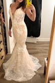 Very pretty dress. I wanted to try the trumpet silhouette, but decided on a mermaid, but this was almost THE dress. 
Really expensive looking for the price and amazing 3d floral details. The color is a little beige, but more white than another beige-lined dress that I tried. If this had a lower back I would've stopped my search though. - Vanessa T.