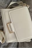 Purse looks extremely awkward and as though it was not sewn correctly. - Shannon A.