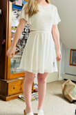 I really liked this dress when I saw it on the site, it's super flattering and ultimately such a cute graduation dress. however, it is incredibly see-through, even with a white bra and thong you can still see underneath in certain lighting. I loved it, I thought it made me look really really young for a high school graduation so I ended up going with a different dress. but it is super flattering and I bet would be good in a darker color :) - Kaylee M.
