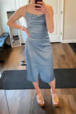 Color is definitely more dusty blue than the bright luminescent blue as depicted. Fit is fine, just didn't keep because I felt like it just didn't do anything for my legs. The slit is minimal unless you're standing with a pretty broad stance. - Katie B.