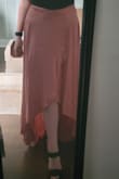 I feel like this skirt is perfect for the summer because it can be worn as a swim cover up, dressed down or dressed up with a pair of heels. It is breezy and flowy and looks great with t-shirt, bodysuits and light knit sweaters. It does touch the ground without heels (I'm 5'2"), and it needs to be steamed before wearing anywhere fancy! - Cayleigh B.