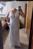 This dress is even more beautiful in the photos than I thought it would be. Didn't realise that all the design is tiny white sequin which gives it a beautiful shimmer without the bling. Because of how it fits, I don't think it will scratch my arms at all. It fits perfectly, and with a 3" heel I won't have to get it altered as it skims the ground. Saw a bunch of people dress it up Gatsby style, and the art deco design really fits well with the theme. Can't wait to wear it. - JC C.