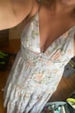 This dress has stretch in the back, as well as tie straps that make it adjustable. The lavender print is beautiful! Planning to wear to my best friends bridal shower. One of the buttons popped off as I was pulling it over my hips, so be careful. It's very delicate! I have a smaller bust and this makes me feel very confident. - Marina N.