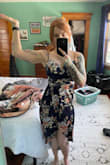This dress is a bit tight on me in the torso, as in, it's an event to get into but once it's zipped it's gorgeous and comfortable. I don't have much bust but I do lift, so if in doubt on your lats or ribcage, I'd size up one. Straps are adjustable and I love the high-low hem.
Please enjoy one posed photo and one feral, candid photo. - Nicole H.