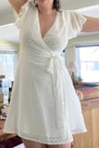 I wore this dress for graduation and it fit great! I was surprised by the quality. Even though it was white the fabric was thick enough to not be see through. I would recommend fashion tape or a pin for the top... the dress stayed covering me the whole day but was a little too low cut for me unless tied very tight. - Sarah S.