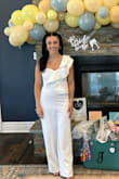 I wore this jumpsuit for my bridal shower and received many compliments. I opted to not wear a bra (wore sticky covers) and went commando to avoid lines and it was just fine that way. It fit my rib cage perfectly, and had grippy strip at the top to keep in place which worked great. I was very nervous about fussing with it the whole party. I still used some fashion tape for the shoulder strap but it wasn't necessary. The length of the pants was incredibly long when I first got it, but it was easy enough to hem it to the appropriate length with my heels. Material was very stretchy and forgiving, and I was comfortable the whole event. Would 10/10 recommended for any bride looking for a jumpsuit and not a dress for an event. - Brooke R.