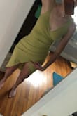 I really love the fabric of this dress, the color, and the way it feels. The fabric is nice and thick but very stretchy so it was very flattering across the belly/butt area. I ordered an XS and it fit perfectly because of the stretch. However, I returned it because (very sadly) there are two very weird elements about the style: the double asymmetrical shoulder and the slit length.
I love a high slit - I like my legs and am NOT modest about length. But this slit was VERY high. It was maybe one inch below my crotch (which you can see by where I'm pointing in the photo) and I have an average size torso... so this is how it will fit everyone. I literally wouldn't have been able to walk in this dress without people seeing my underwear.
Second, the shoulder straps: if both shoulder straps were the same type (like two spaghetti or two wide), the shoulder would look great, or if they were on either side as I have it in my picture. As it is, it looks weird, like it was accidental to make it so asymmetrical. - Delaney R.