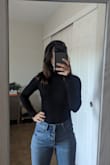 Hard to go wrong with a simple black turtleneck!  Not too thick, and will be good for layering for my trip to Europe this fall. I usually wear XS, so that's the size I purchased. The XS sits higher on the hips than I anticipated, which works really well with higher waisted jeans as long as I don't raise my arms straight up. The sleeves are a bit long but can easily be folded up. Overall, good product for the price. - Ariadni K.