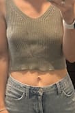 This crop top on the model meets her high-waisted skirt, seeing that the model was 5'8 I thought it would meet my high-waisted jeans with no problem since I'm 5'2. The XS was so short, it looked like a child's shirt. I exchanged it for a small thinking I would get some more length. It was still much smaller than I expected. I'm disappointed that I had to return it, it's so cute but just wouldn't work for me. - Elizabeth G.