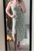 Bought this dress for a wedding and wanted it to fit like the photos, but at 5'3 135lbs I wasn't sure if I should get the small or medium so I ordered both. I ended up going with the small to get the more fitted look, and the medium was too loose for my taste. If you want a more forgiving fit go with the size chart, if you want it more fitted you may consider sizing down. 

This falls just below the knee on the model who is presumably tall, and about mid-calf for me at 5'3. I wore it the way it came, but will probably hem it up a couple of inches in the future. Being on the short side I also felt like the slit would look best if it hit slightly higher on me so may adjust that for the future too. If you're taller these wouldn't be an issue of course. - Olivia L.