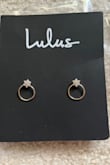 One of the earrings came in a little bent (left in pic). The holder is also bent with sticky residue on the back of it. I'm not sure if these were someone else's returns or if there was a shipping error. - Kristen S.
