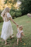 This dress is stunning. The detail of the fabric is so beautiful and the fit is perfect. I received so many compliments and it photographed beautifully for our family photos. 10/10 recommend. - Natalie C.