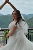 This dress was absolutely beautiful for my wedding! Will warn my bustier gals that the straps are elastic and don't provide much support, but I had solid straps added underneath the elastic and it fit beautifully - Britian J.