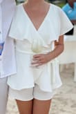 I wore this to my beach welcome event for my wedding weekend. It fits true to size, and you can adjust the wrap to fit tight or loose depending on your preference. The open back is a very cute feature! This outfit is very flattering, and had just the right amount of 'flowwyness' while also offering some structure. - Malou M.