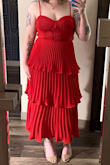I ordered this dress as a last-minute replacement before an event, but it worked out great. Looks much more expensive than it is. The skirt moves and flows beautifully, and I felt very pretty. I will wear it again.

I don't often wear red but the color is beautiful, not too orange or too pink. I got many compliments on the color.

It was tight around my rib cage, but I'm not sure that sizing up would have been a better fit. There was no stretch in the bodice so sitting was not very comfortable. I do think the bodice being fitted helped prevent the "extra material" look some other reviewers complained about.

As other reviewers have said, the zipper was a struggle to get over the thick layers of fabric at the waist but I got it zipped myself. (With the dress halfway on and the back turned around to my front I could get leverage and see what I was doing. Once the zipper was past the waistband I was able to twist it back around, put my arms through the straps, and zip it the rest of the way up.) - Celia C.