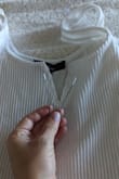I loved this shirt but wore it once and the V-shaped wire started poking out on one side. I thought I would wash it and then try to stitch it closed before wearing it again. Nope, the whole piece somehow came out through the tiny hole in the wash. (Washed on delicate and did not dry.) I'm not even sure how that even happened but without the wire to give it structure the neckline droops and makes the shirt unwearable. Pretty unfortunate considering the price. - Faith E.