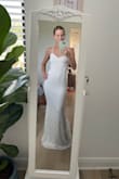 I love this dress& it is romantic but not overdone. Sexy but not too sexy for a wedding. Just my style. Fits like a glove. Only need some cups sewn in, hem the bottom and possibly a bit at my hip dips lol but really wouldn't make a huge difference if I skipped the hip hemming. I cannot believe I found my dress at this price either. It looks very similar to another I liked that was $2500 from another designer. Got some beautiful shoes from Lulus as well. I'm wearing them in the photos. So happy. Can't wait to get married in it! - Rachel D.