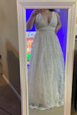 I love this wedding dress. I ordered several different ones from Lulus and this was by and far the winner for me and all my friends and family members who saw pics. Size medium was sold out and probably would've been the right fit, but I got a large size and simply have a tailor taking in the straps and hemming it. The tailor said it's a super easy project and so even though there are several layers of skirts and lace details, it's fairly inexpensive to get it fitted just right (around $100 all told). It looks like a much more expensive dress in person and the skirts have a lovely movement to them when walking and turning. If you have a big tummy, the waist of the dress seems to sit higher on your stomach and the skirts are full, so it disguises any fupa business. Also, the neckline plunges more than it looks on the model, so taking in the straps if you're a short queen like me will help reduce how much your tatas are saying hello during the ceremony. The picture is from BEFORE tailoring. - Jamie F.