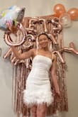 Wore this dress for my bachelorette. It does fit a little tight and the feather material is delicate so I was nervous about pulling it off the dress, but it ended up being fine.
I loved the way it looked though and I got a lot of compliments on it! - Sierra H.
