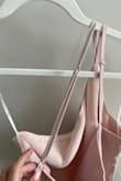 Cute top, plan to not wear a bra with it. 
My issue is with the straps. They are adjustable which helps with how the garment lays. However, the straps were sewn in while twisted. Unable to straighten them and the adjuster sits right on my skin. Unfortunately after purchasing, the item was set to final sale.

My issue may be a one-off. Other than this minor annoyance the top is perfect. - Erica D.