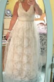 The dress absolutely fit true to size. Color was different than expected. More beige with white lace overlay. Going to be honest the dress I received had a weird odor. It was pretty just not for me. Well made definitely worth the money. If I choose to keep it would probably remove the tulle overlay. Beading in the middle was beautiful. - Heather L.