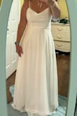 I read the reviews and ordered the larger size. Medium would not have fit. This did fit beautifully but I would've had to remove some of the length for a beach wedding. This dress surprised me it was more elegant and beautiful in person. I didn't choose this dress but it was definitely in the top 3. - Heather L.
