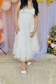 This is literally the perfect bridal shower dress! It has strings in the back to adjust it to your liking. Im 53 and it was a little long but it was really no big deal. I paired it with short heels and a headband and received a ton of compliments. The fabric itself is not cheap, and the butterflies, although delicate, didnt come off so win, win! Order it! - Daniela M.