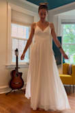 I bought this dress for my backyard wedding. Its simply and flowy and the transparent lace panel on the back adds an elegant touch. The skirt has two layers and the top layer is slightly transparent and twirls well. The buttons on the back are not flush with the fabric on the back because of the way they are shaped, but its not noticeable. This dress is affordable and beautiful. - Althea K.