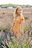 I  bought this dress for a photoshoot and it was a hit! The material is high quality and well made. Its thick enough not to be see through but light enough to wear on a warm day, The chest was more open that I'd like so I  ended up tying it tighter instead of a regular bow. See at the picture I posted to notice the knot I made. The slits on both sides allow this to be a mind but comfortable dress to wear all day. There is no stress, so buy based on your waist and hip measurements. Enjoy! - Diana C.