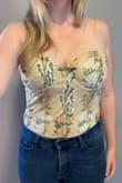 This is such a beautiful top! Although I was a little nervous about purchasing because of my bigger bust size and the "corset" like cups, it fit so well and was form-fitting in the best way. The embroidery is even more beautiful in person, and I loved the sheer back. The front and cups are lined well, making the contrast with the sheer back even more standout. I would definitely recommend it. I wore it for my birthday and got lots of compliments on how unique it was! - Erin S.