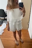 The size fits just right and with certain poses it looks great, but when you lift your arms the top layer flares up and looks so awkward. - Alexia G.