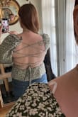 I recently purchased this adorable top for a fun, flirty blouse to wear on date night or a day off and I love it. I'm usually a size 6 or an 8 and wear Mediums in most of my clothes but with Lulus tops I'm finding size Large tends to be the way to go for me. I have broad shoulders. A bra is optional. I love that you can tighten the corset straps if needed. The shirt is a lovely olive green. Not wearing a bra in either picture! - Jenna M.