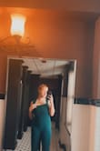 I ordered this jumpsuit for a family wedding. I was absolutely obsessed with it, it truly does fit true to size and looks absolutely elegant. This jumpsuit, unlike others, does not have much cleavage, and is a full, zipped back. However, it does run a little long in the legs for a size large, so I would suggest wearing with heels or downsizing, depending on your body. - Julia G.